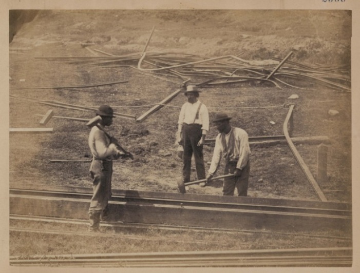 'Two railroad construction workers hammer track as third construction worker watches' by Andrew J. Russell; Library of Congress, LOT 9209, no. 66 [P&P]